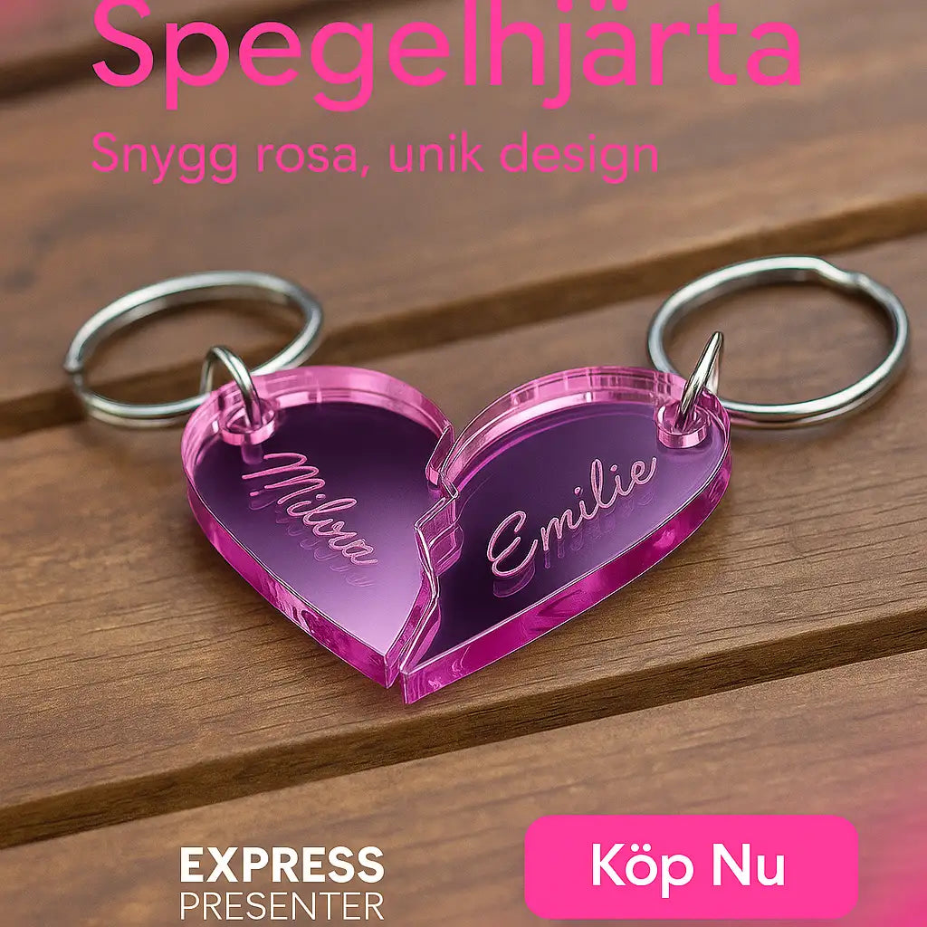Nyckelring - Halvt hjärta i spegelplast (rosa)" från Express-presenter är en hjärtformad nyckelring (4x3cm) i rosa akryl delad i två med namnen Milda och Emilie ingraverade, visad på trä med svensk text och Köp Nu-knapp.