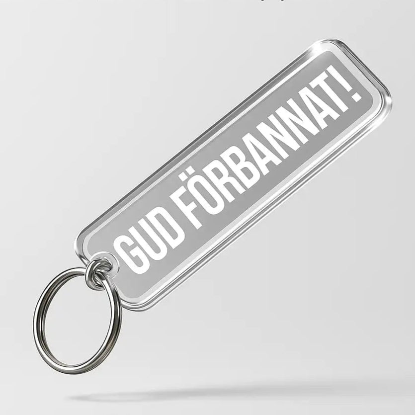 Nyckelringen GUD FÖRBANNAT från Express-presenter är en rektangulär akrylnyckelring med metallring, fet vit text på grå botten, 60x15mm tryck, 3mm tjock, och graverad baksida för extra detaljrikedom.