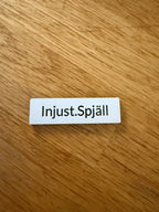 Märkskylt | Injust.Spjäll 42x12mm