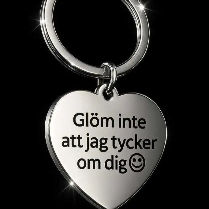 Nyckelringen Glöm inte att jag tycker om dig från Express-presenter är en silverfärgad, hjärtformad nyckelring i rostfritt stål med den svenska texten "Glöm inte att jag tycker om dig" och en smiley - en perfekt omtänksam present.