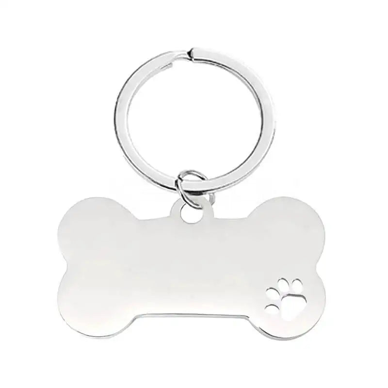 En silverfärgad nyckelring från Express-presenter, formad som en hundben med en liten tassavtrycksutskärning - snygga och praktiska accessoarer för djurälskare.